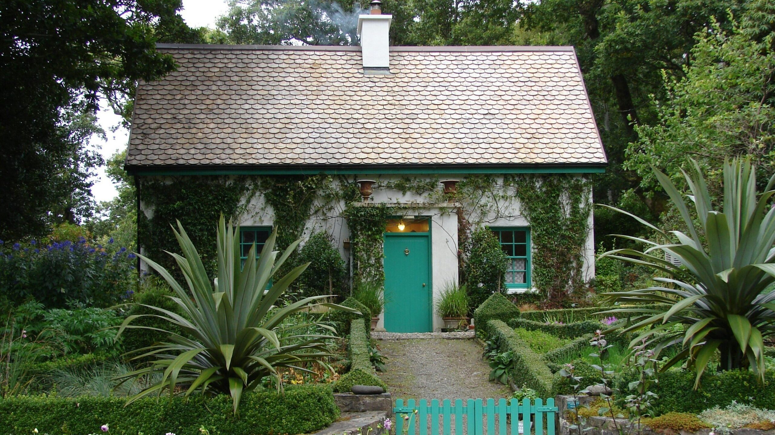 short term rental restrictions- nice white house brown roof surrounded by foliage and palms