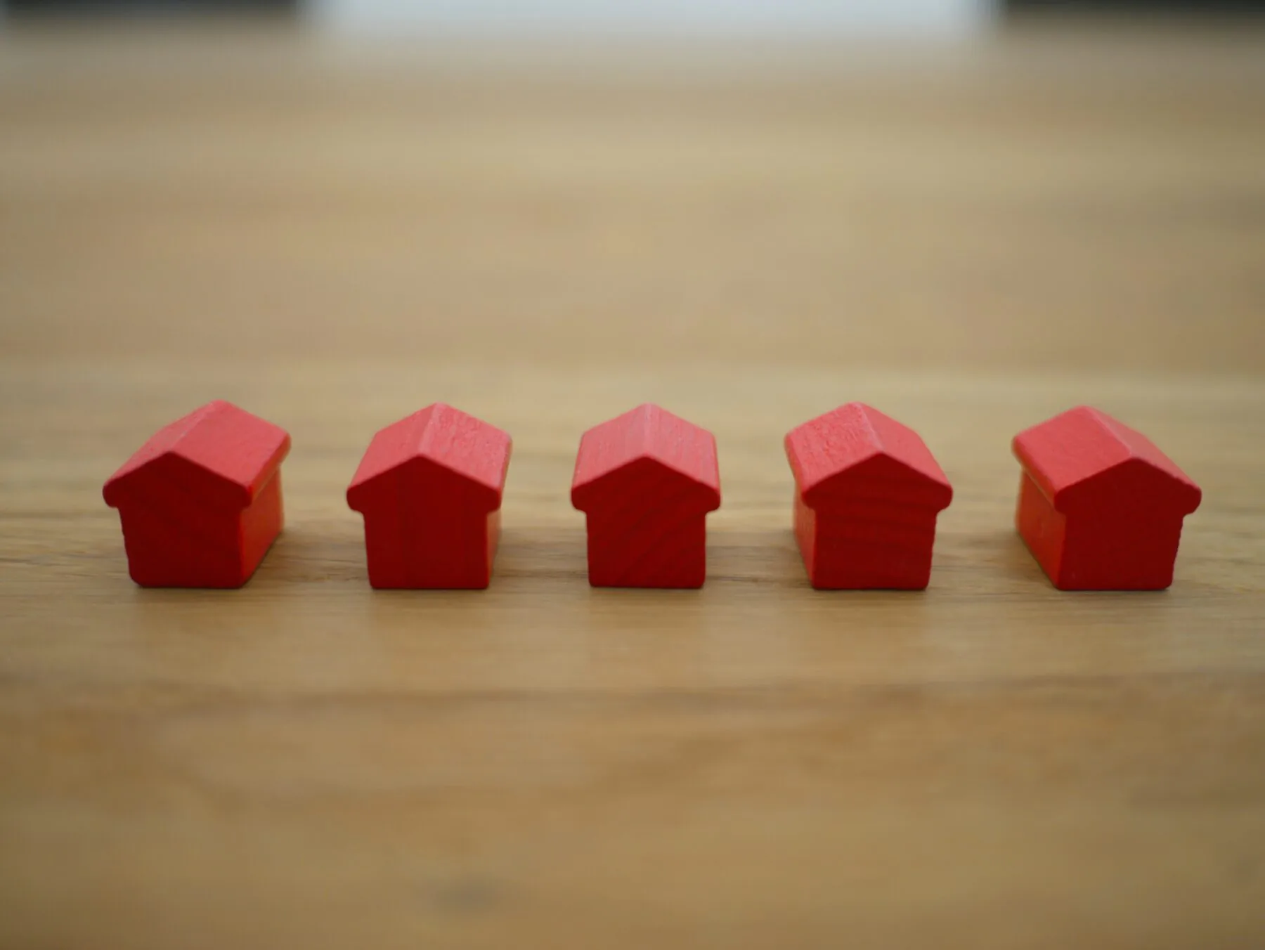 5 red houses on a wooden table mortgage payoff