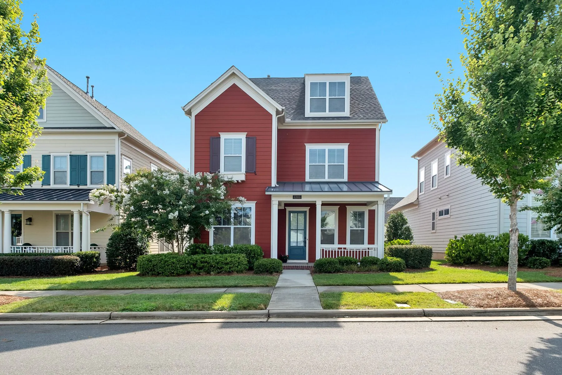 red house with gray roof on a street in spring mortgage payoff